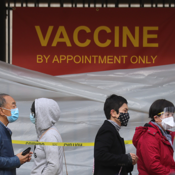 People with appointments stand in line to receive the COVID-19 vaccine at a vaccination site at Lincoln Park in East Los Angeles amid eased lockdown restrictions on January 28, 2021 in Los Angeles, California.
