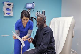 Nurse reviews surgery instructions with patient