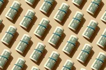 rolls of dollar bills with rubber bands on them