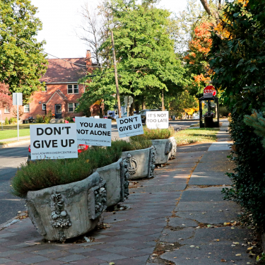 Series of lined up signs focused on mental health assistance during the Covid pandemic crisis.