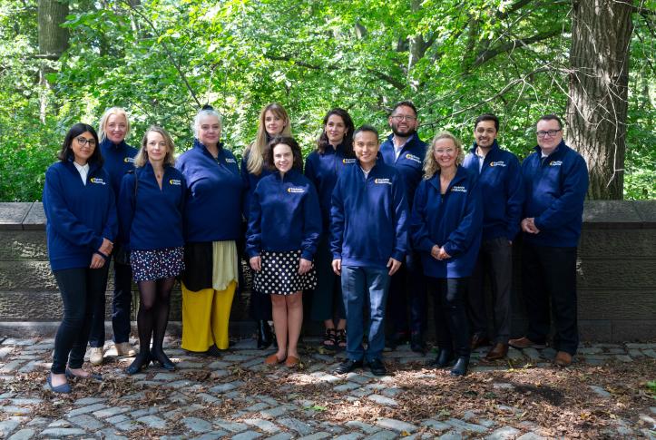 Photo, groupshot of Harkness Fellows in front of Central Park greenery