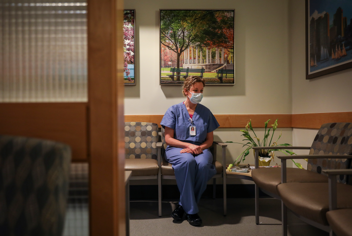 Nurse sits in hospital lounge.