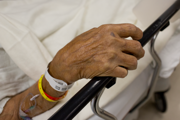 An elderly patient admitted to the emergency room waits to be seen by a doctor.