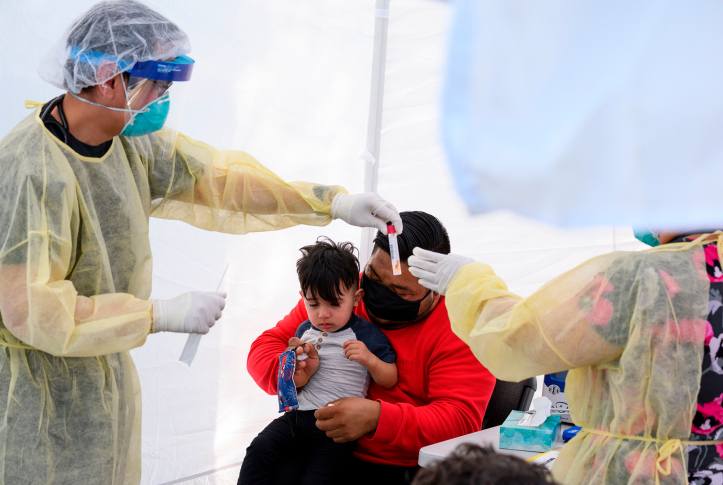 Child getting tested for COVID-19 at a mobile testing station