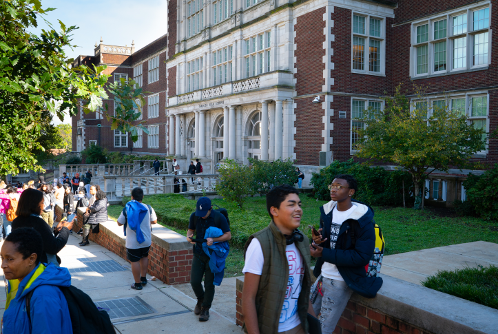 Photo, high school students in front of school buildings