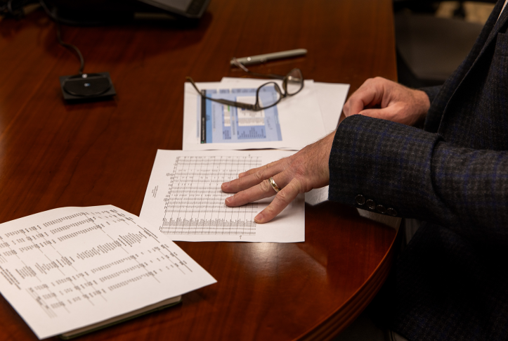 Hand looks at paper work on table