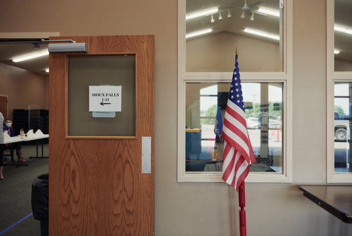  An American flag stands on display at a polling location in Sioux Falls, S.D., on Tuesday, June 2, 2020. Residents of South Dakota, one of 12 states that have not yet expanded Medicaid eligibility under the Affordable Care Act, will vote on expansion in the November midterm elections. Photo: Dan Brouillette/Bloomberg via Getty Images
