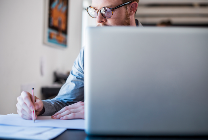 man on computer doing paperwork