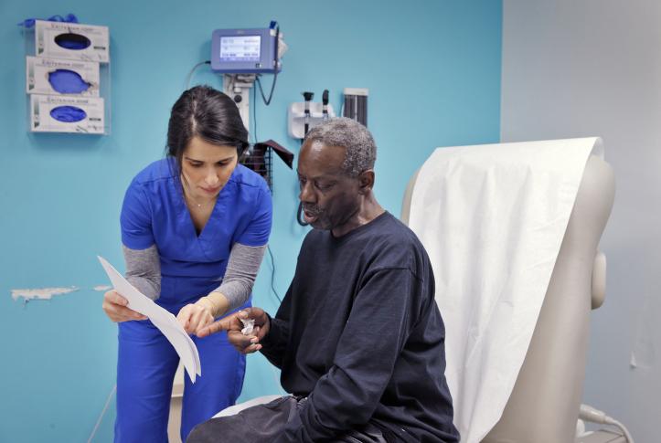 Nurse reviews surgery instructions with patient