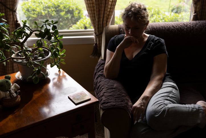 Woman sits in chair