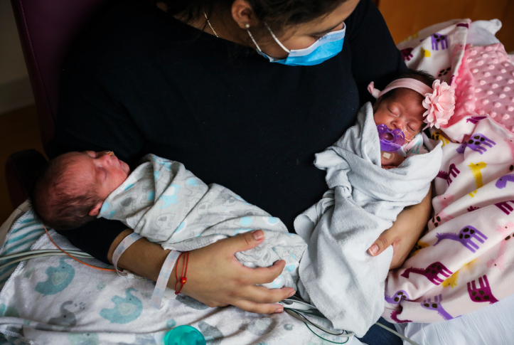 Lisseth Hernandez holds her twins in the neonatal intensive care unit at Tufts Medical Center in Boston on May 13, 2020. As Medicaid eligibility redeterminations resume after a three-year hiatus because of the COVID-19 pandemic, continuity of care will be critical for people who are in the midst of treatment, pregnant, or have serious chronic conditions. Photo: Erin Clark/Boston Globe via Getty Images