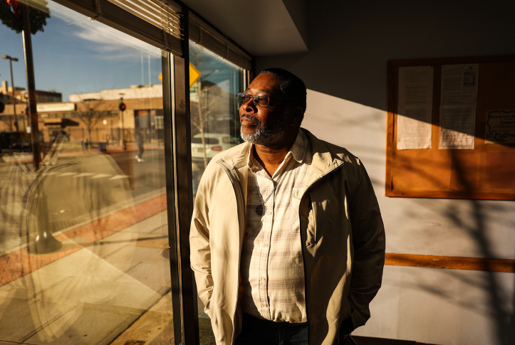 Photo, man stares out window