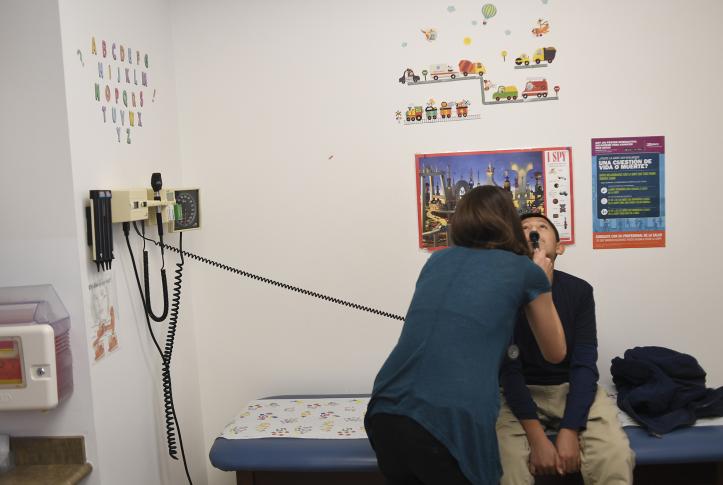 A pediatric doctor performs an exam 