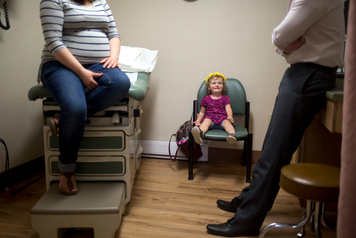 Pregnant mother and daughter at doctors office