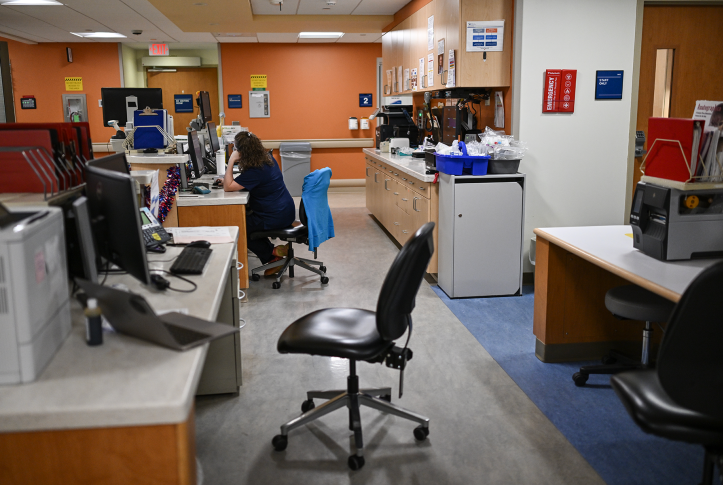Nurse sits at computer in hospital