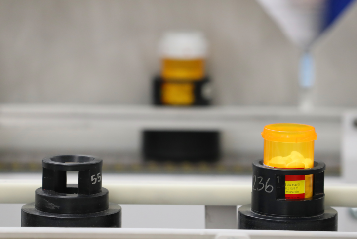 Bottles of prescription drugs move down an automated line