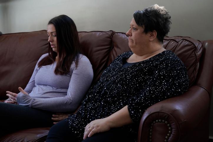 Mother and daughter sitting on a couch