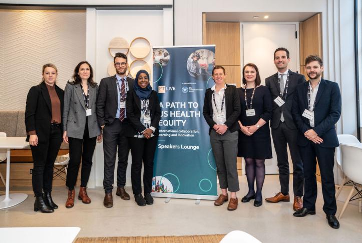 Harkness fellows stand in front of sign reading "A Path to Health Equity"