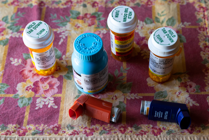 Pill bottles on tablecloth with inhalers