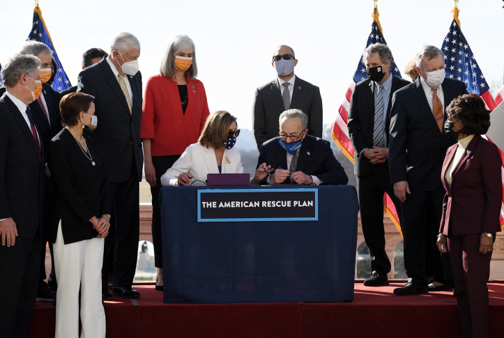 Speaker of the House Nancy Pelosi and Senate Majority Leader Chuck Schumer sign the American Rescue Plan Act after the House Chamber voted on the final revised legislation of the $1.9 trillion Covid-19 relief plan, at the US Capitol on March 10, 2021 in Washington, D.C.