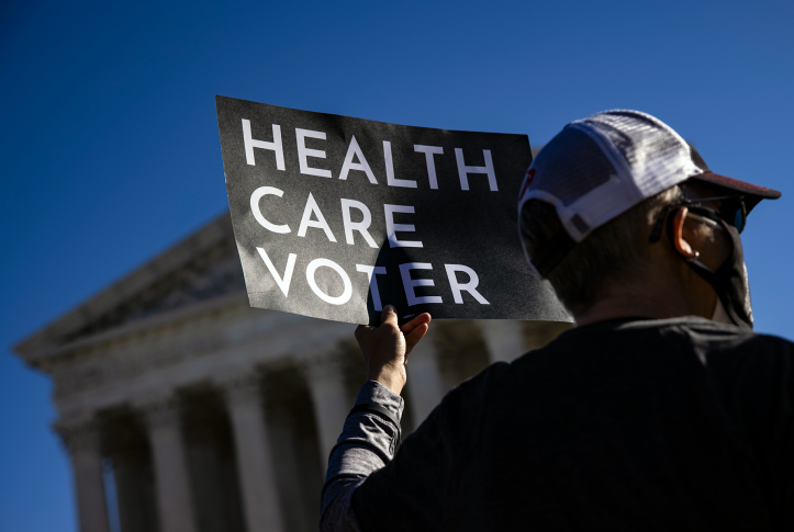 A supporter of the Affordable Care Act (ACA) stands in front of the Supreme Court of the United States as the Court begins hearing arguments from California v. Texas about the legality of the ACA on November 10, 2020 in Washington, DC.