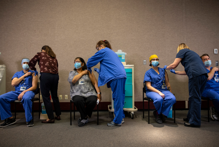 Healthcare workers receiving vaccine in line