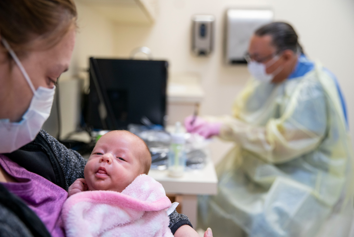 Cerri McKeon holds her two-month-old daughter at the Min No Aya Win clinic on the Fond du Lac reservation in Cloquet, Minn., on May 6, 2020. 