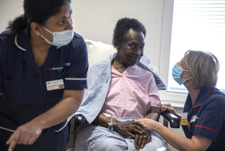 Elderly Black woman receives COVID-19 vaccine at NHS facility