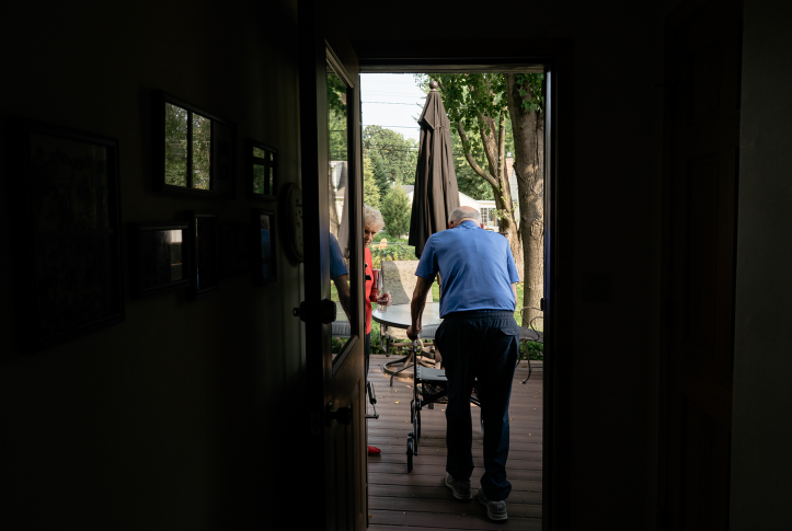 Elderly man and woman at door on their deck