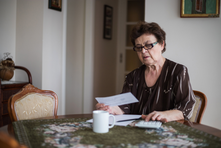 Woman looks at bills