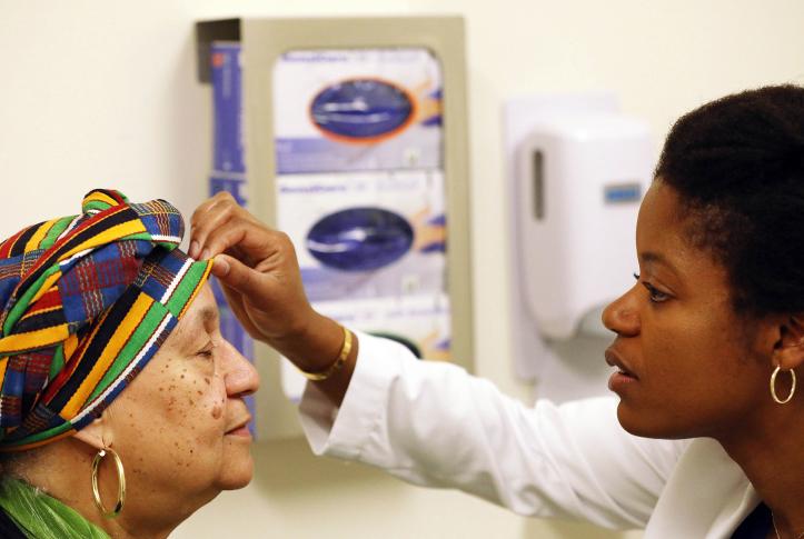 Doctor examines patient in exam room