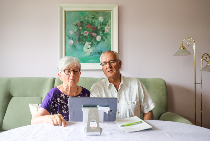 Two seniors look at computer