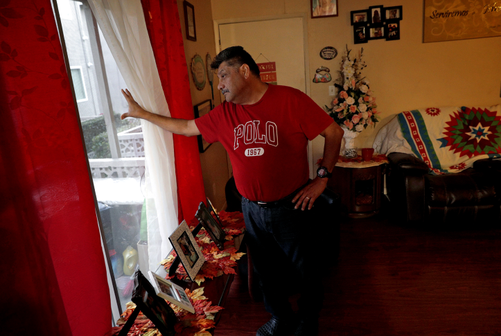 Man looks out window in home