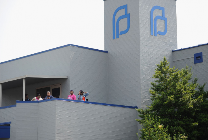 Planned Parenthood employees look on from the balcony to a demonstration outside the Planned Parenthood Reproductive Health Services Center