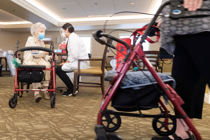 A CVS pharmacist intern talks with a resident at Emerald Court senior living community in Anaheim, CA on Friday, January 8, 2021 after giving the Pfizer/BioNTech COVID-19 vaccine.