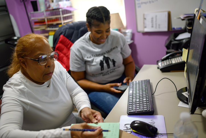 Geneva Cooley, 72, learns how to use the internet and sets up a gmail account with the help of re-entry coordinator Donna Collins at the Aid to Inmate Mothers house two days after getting released from a life sentence without parole.