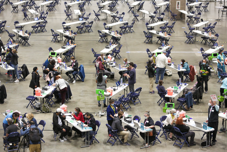 crowded room of people getting vaccinated