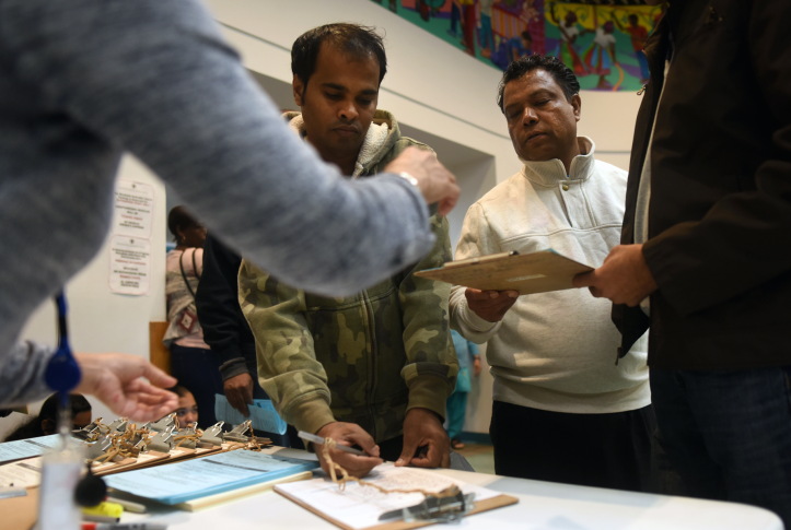 People fill out paperwork to enroll in or renew their health care coverage at the Montgomery County Department of Health and Human Services office in Silver Spring, Md., on Nov. 1, 2017.