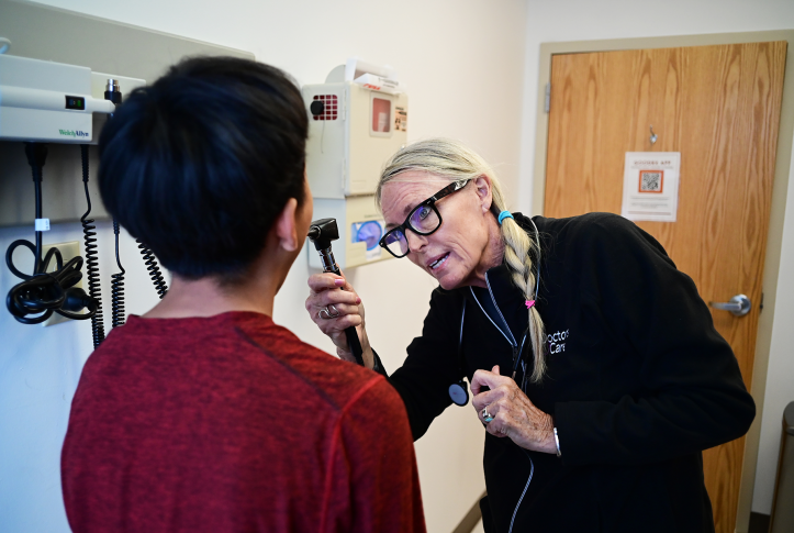Physician assistant looks in patient's mouth