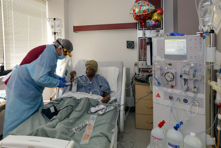 VICTORVILLE, CA - APRIL 29: Jennifer Stolpp, left, a dialysis nurse, prepares COVID-19 patient Janice Brown at Desert Valley Medical Group. Victorville, CA. (Irfan Khan / Los Angeles Times via Getty Images)