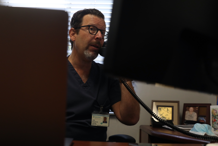 Dr. John Mouratoff talks with a patient on the phone from his office at the East Bay Nephrology Medical Group office in Oakland, Calif., on Oct. 5, 2020. Since the start of the pandemic, at least 20 states have taken action to allow or require coverage of telephone visits — essential for reaching the 42 million Americans who lack broadband access as well as people unfamiliar with video technology. Photo: Lea Suzuki/San Francisco Chronicle via Getty Images