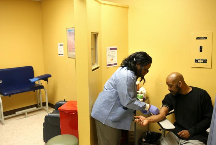 Image of a nurse doing blood work on a patient