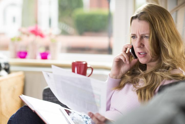 Underinsured woman looking at medical bills