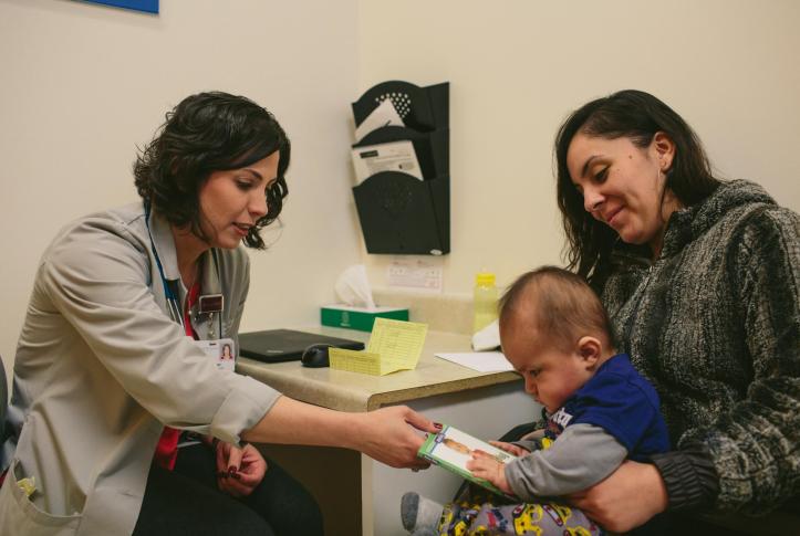 Mother and baby sitting in medical office with doctor