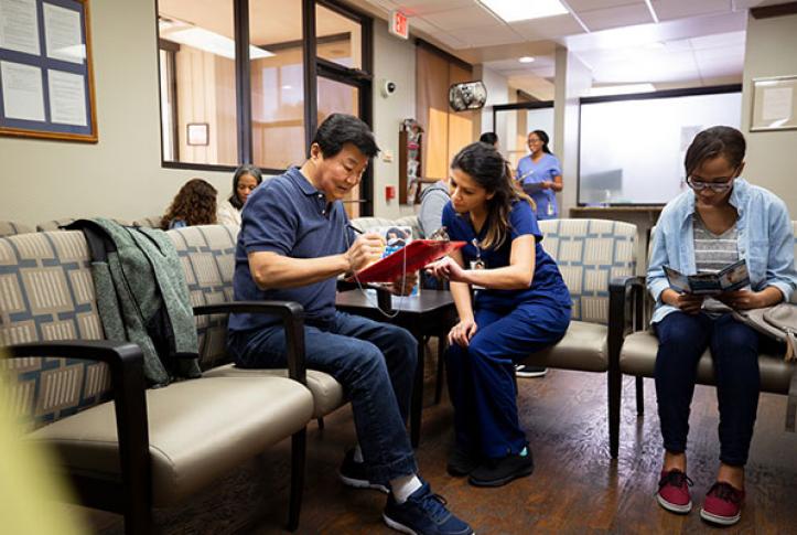 patient-gets-help-from-doctor-in-waiting-room