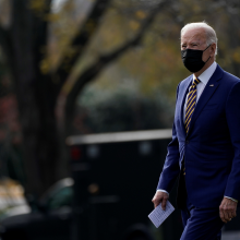 President Biden in a mask walks on the South Lawn of the White House