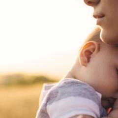 rural woman with new infant in field