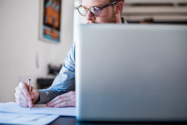 man on computer doing paperwork