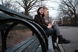Photo, woman sits on bench in park