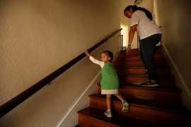 Photo, woman and child walk hand in hand up dark stairwell